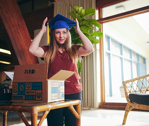 student putting on a graduation cap