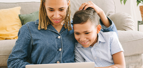 Mother and son watching an online class on their laptop